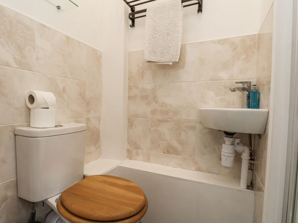 A bathroom with a toilet and sink at Tennyson House in Scarborough