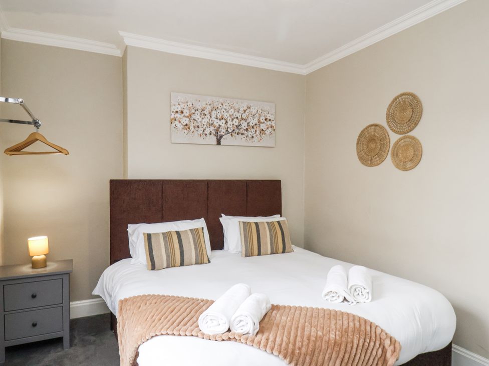 A bedroom with a bed and nightstand at Tennyson House in Scarborough