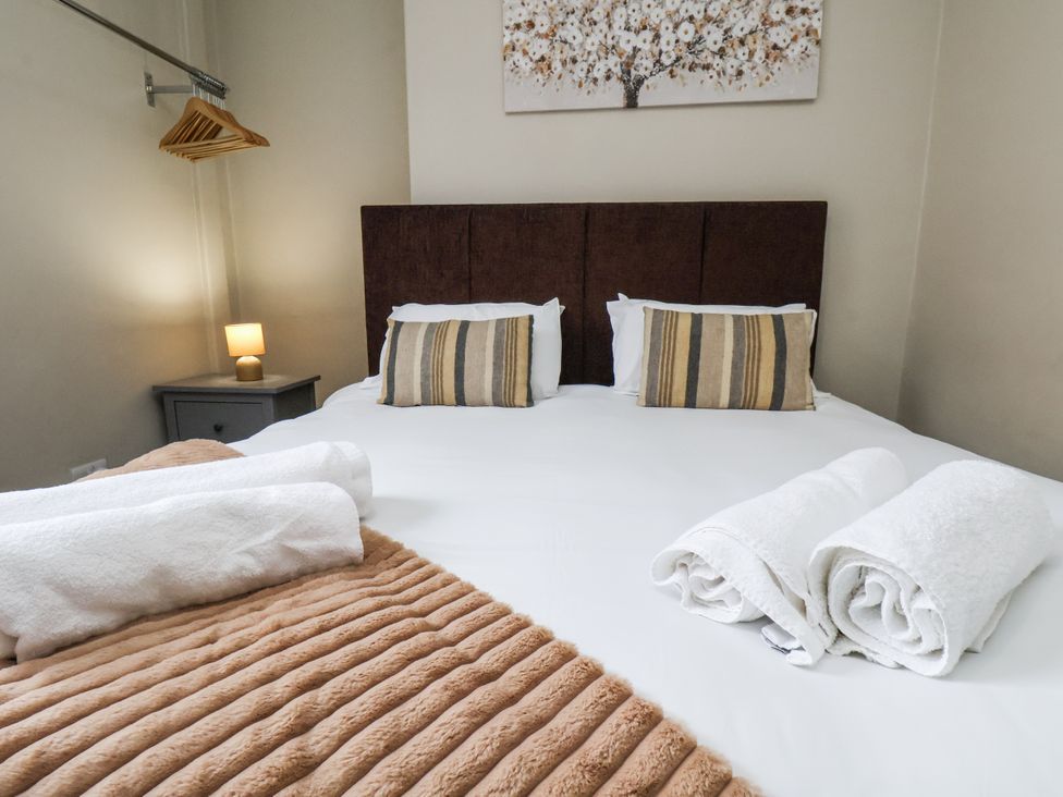 A bedroom with a bed and decorative items at Tennyson House in Scarborough