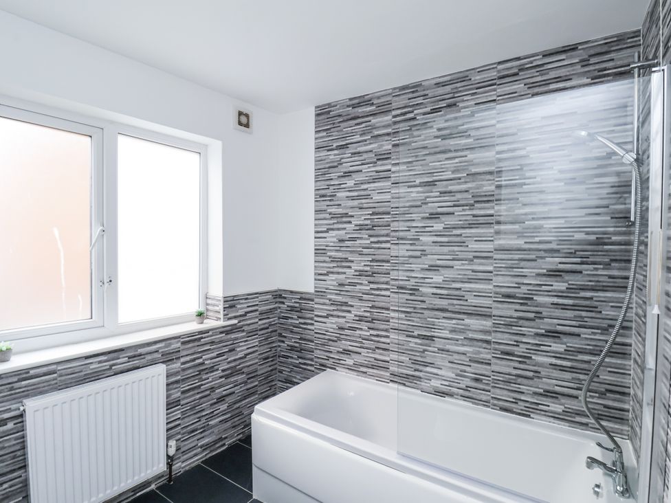 A bathroom with a shower and bathtub at Tennyson House in Scarborough