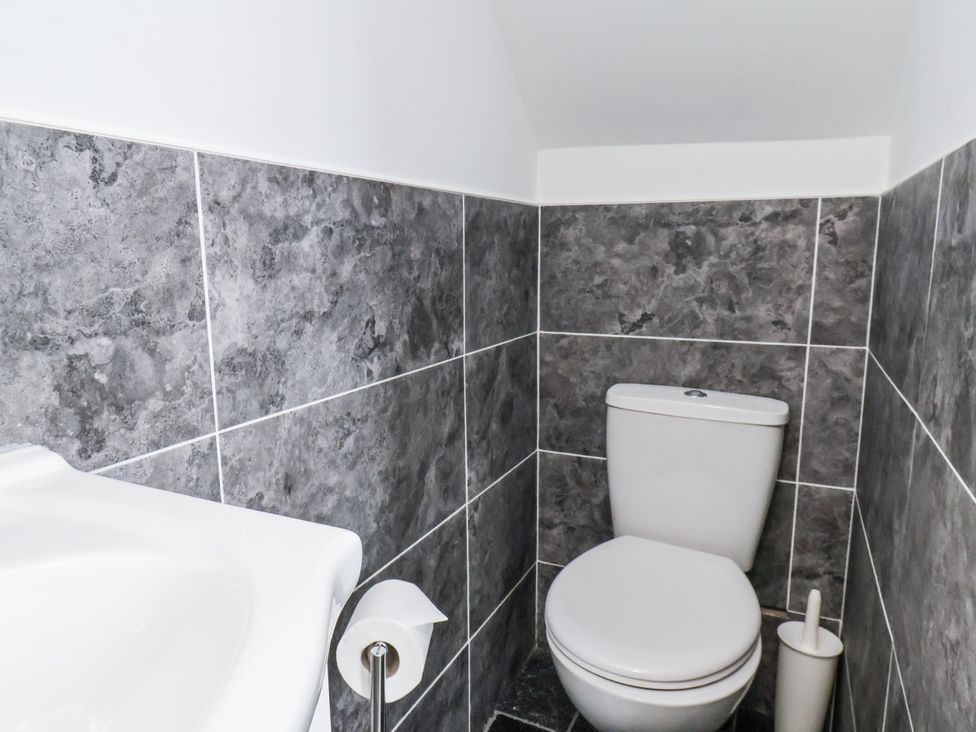 A bathroom with a toilet and sink at Tennyson House in Scarborough