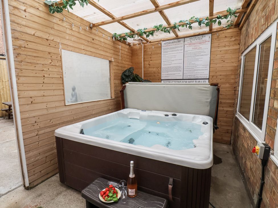 An indoor hot tub with wine and strawberries at Tennyson House in Scarborough