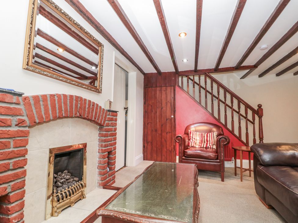 A living room with fireplace and seating area at Dove Cottage in Sleights