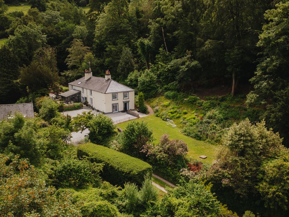 A house with a garden and trees at Cwmalis Hall in Llangollen