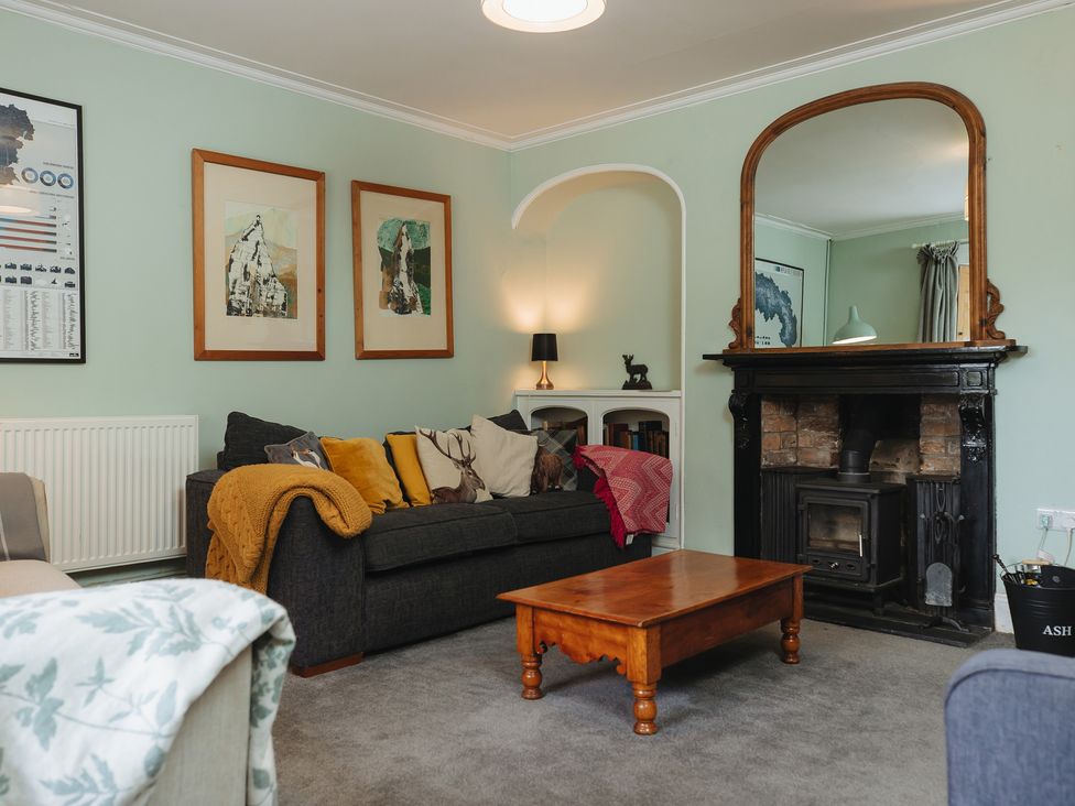 A living room with a sofa and coffee table at Cwmalis Hall in Llangollen