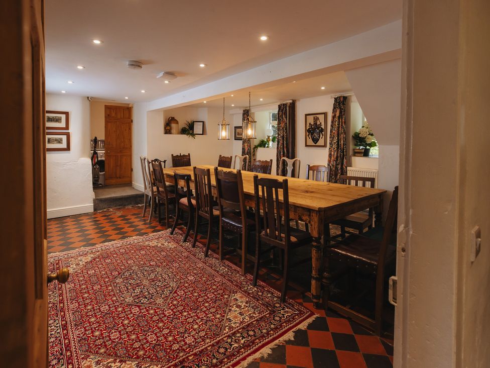 A dining room with a large table and chairs at Cwmalis Hall Llangollen
