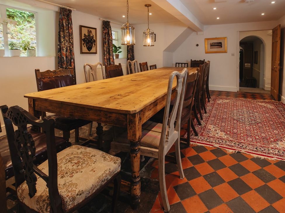 A dining room with a large table and chairs at Cwmalis Hall in Llangollen