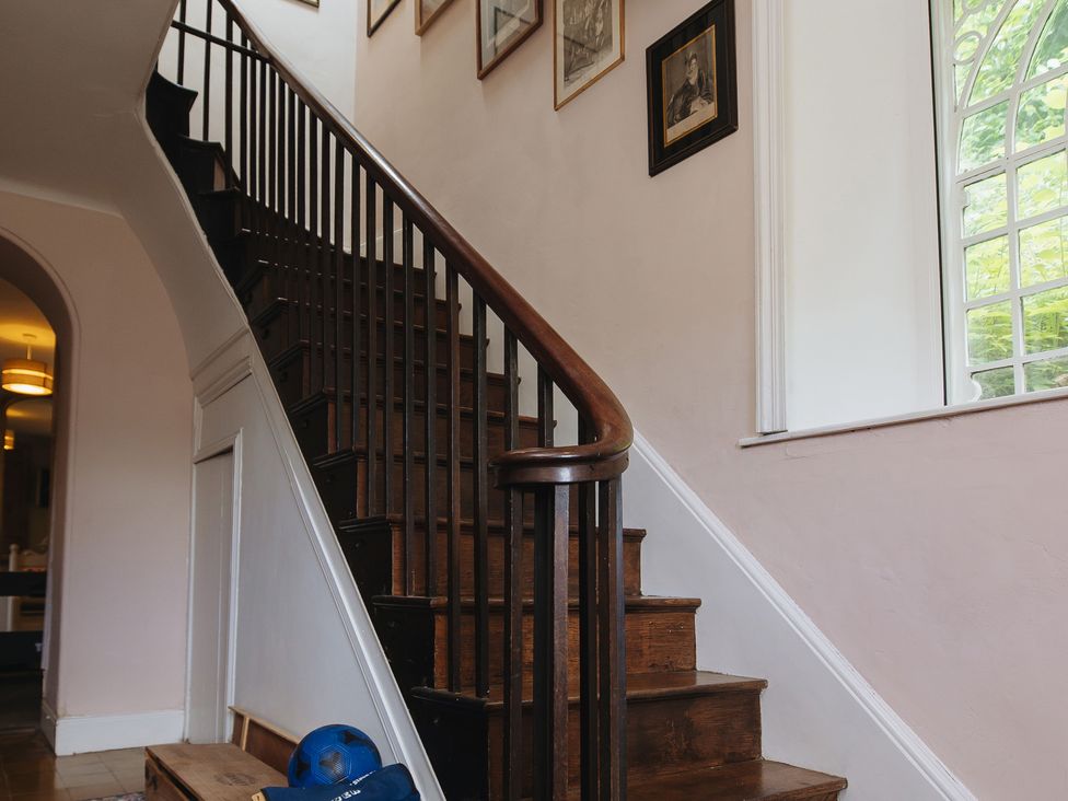 A staircase leading to the upper floor at Cwmalis Hall in Llangollen