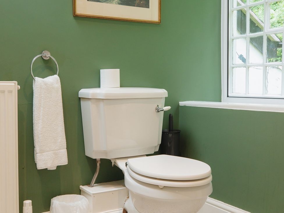 A bathroom with a toilet and towel holder at Cwmalis Hall in Llangollen