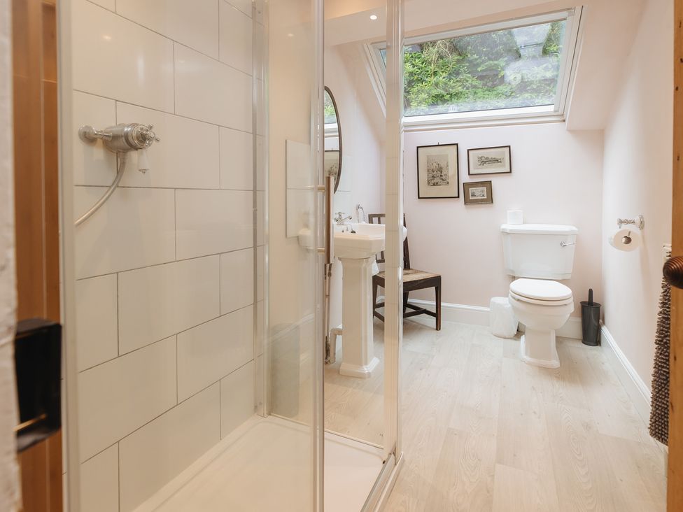 A bathroom with shower, toilet, and sink at Cwmalis Hall in Llangollen