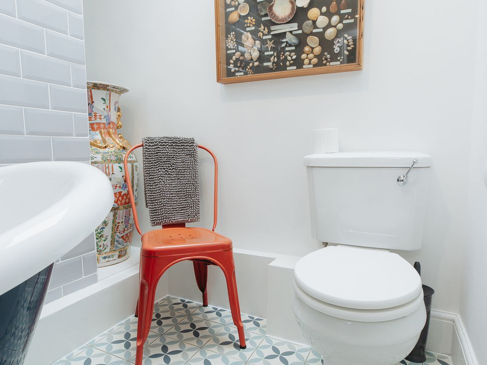 A bathroom with a toilet and a bathtub at Cwmalis Hall in Llangollen