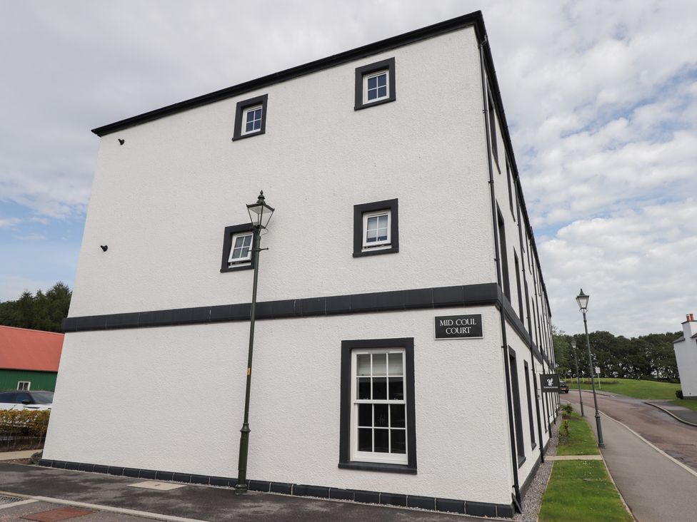 An exterior view of Mid Coul Court with a sign at The Nook in Culloden