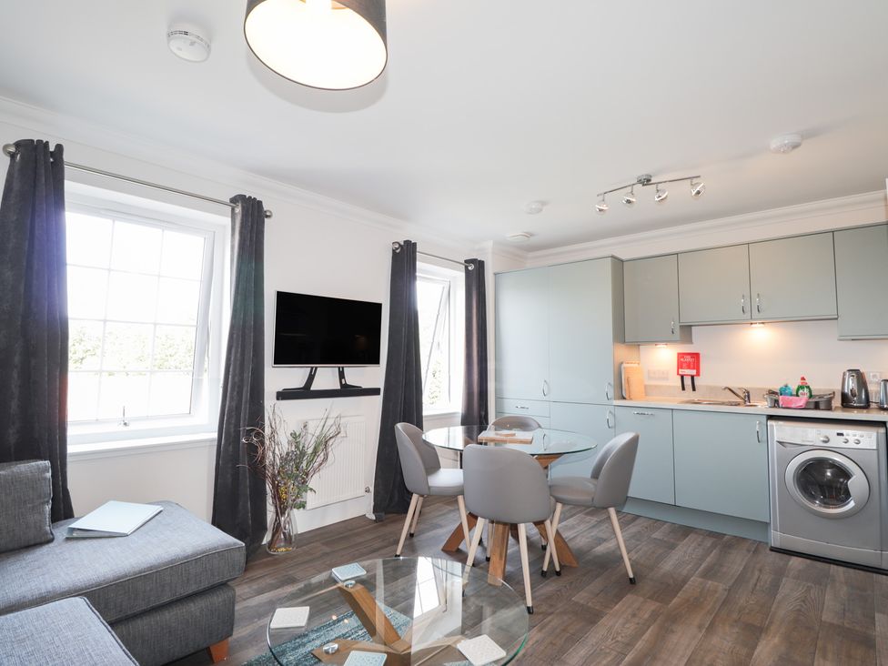 A living room with a sofa and table at The Nook in Culloden