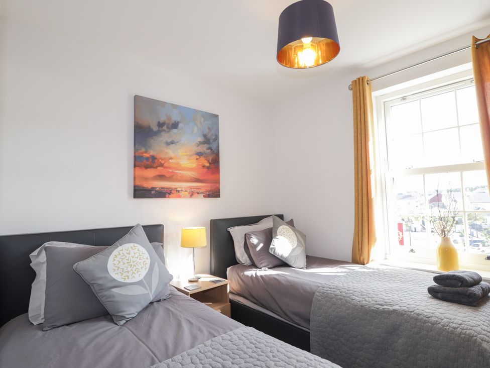 A bedroom with two beds and a painting at The Nook in Culloden