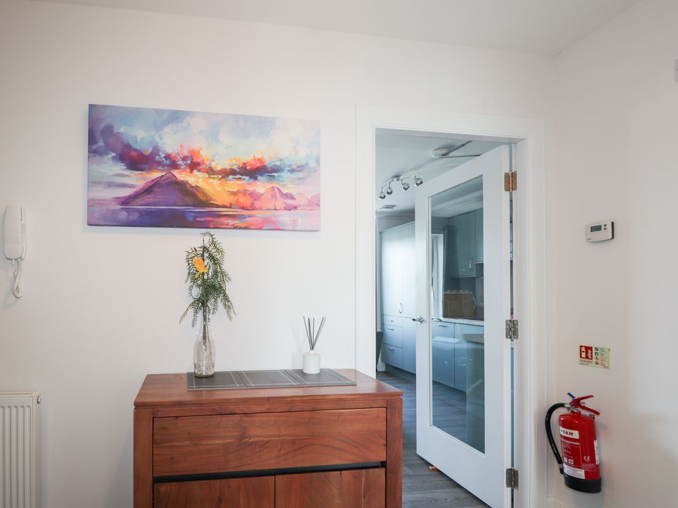 An entryway with a cabinet and a vase on top at The Nook in Culloden