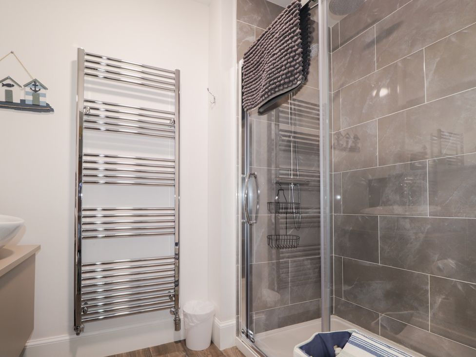 A bathroom with a shower and towel radiator at The Nook in Culloden
