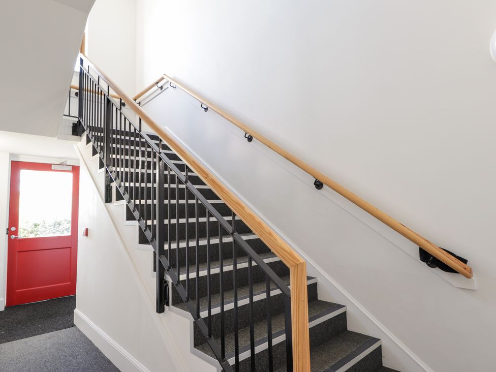 A staircase with a red door at The Nook in Culloden