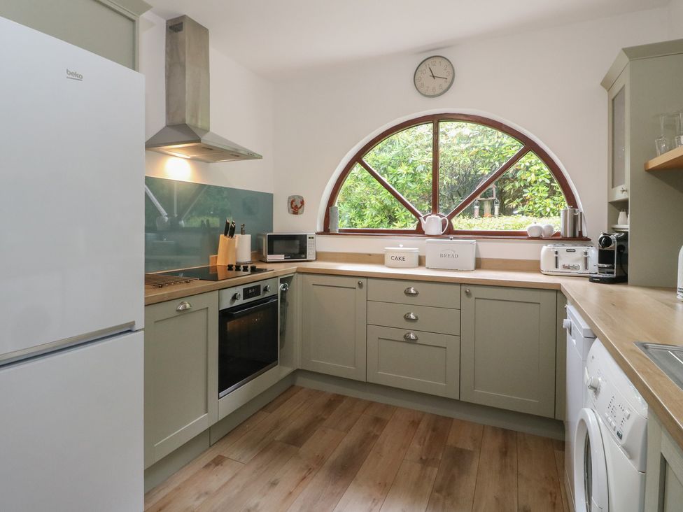 A kitchen with appliances and cabinets at Clearwater House Roshven near Glenuig
