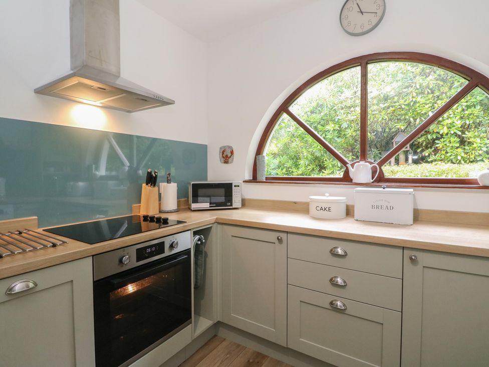 A kitchen with an oven and microwave at Clearwater House in Roshven near Glenuig