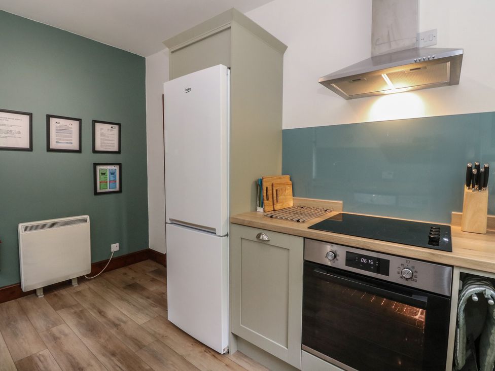A kitchen with a refrigerator and oven at Clearwater House Roshven near Glenuig