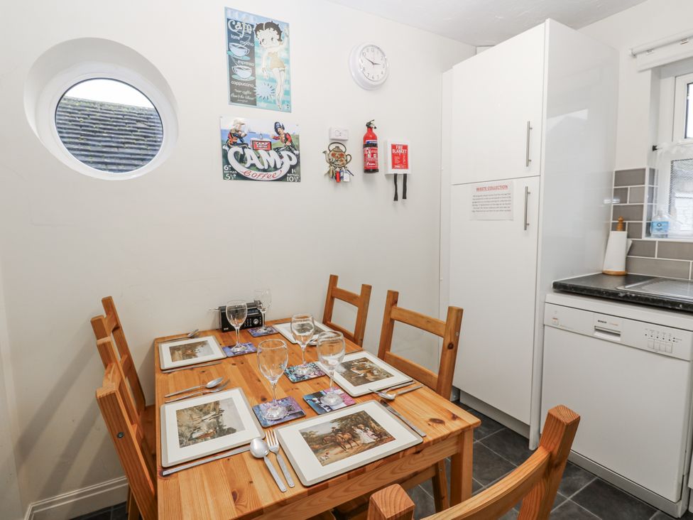 A dining room with a table set for meals at Kelda Garthr (Tranquil Garden) in Middleham