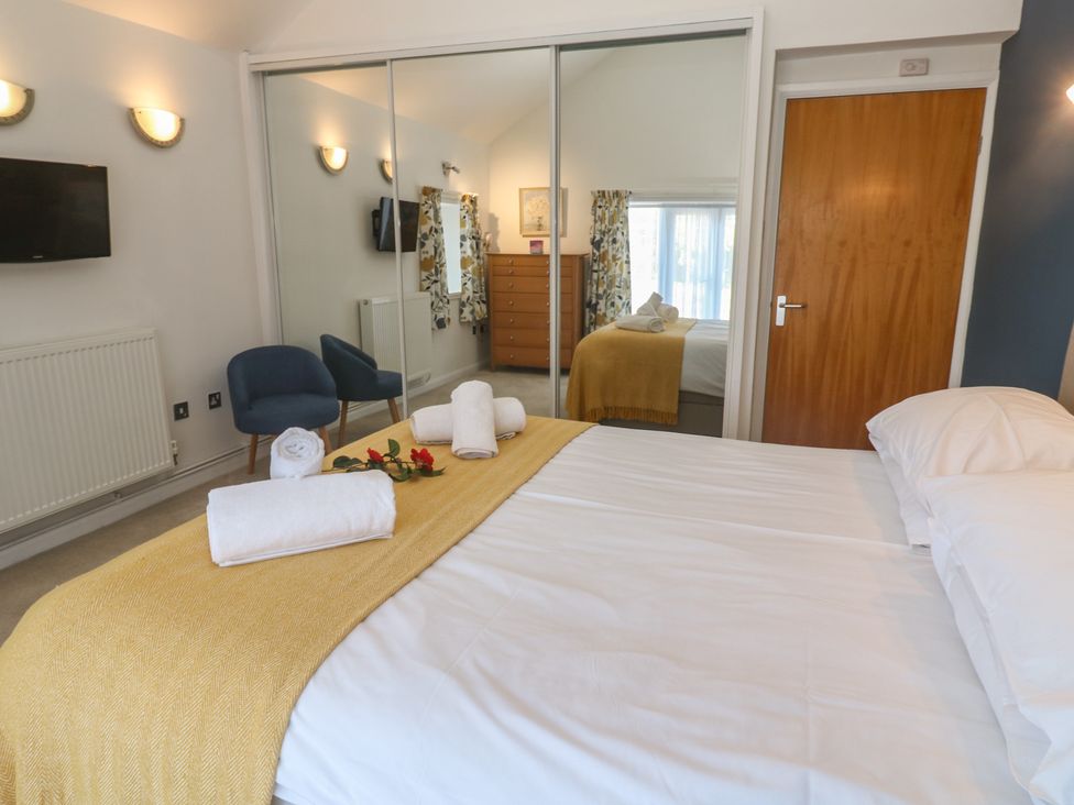 A bedroom with a bed and a dresser at Meadowside in Mousehole