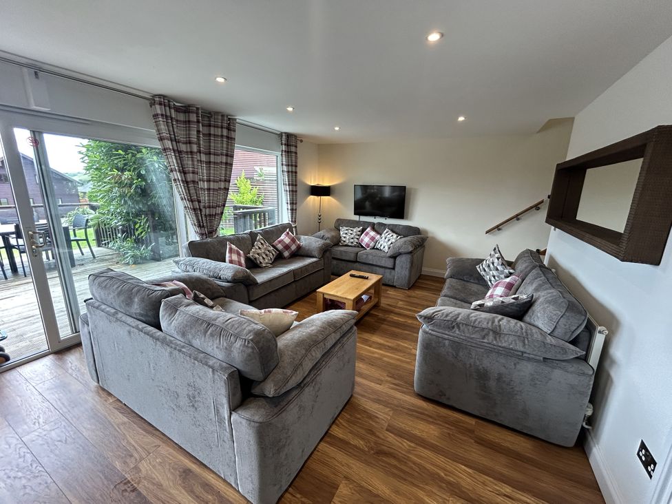 A living room with sofas and a television at Willow, Retallack near St Columb Major