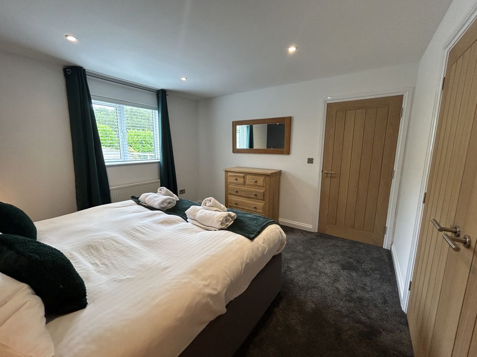 A bedroom with a bed and dresser at Willow, Retallack near St Columb Major
