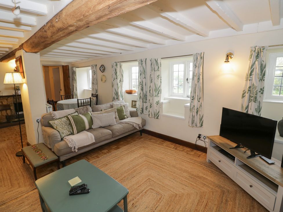 A living room with a sofa and television at Priors Mead in Claydon near Cropredy