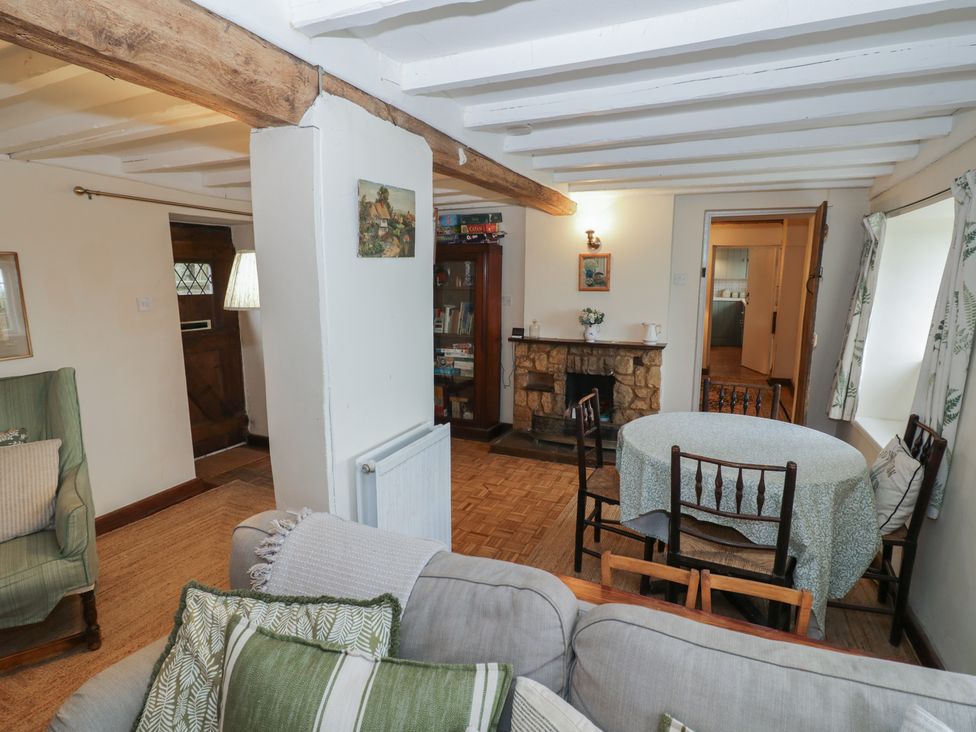 A living room with a sofa and dining table at Priors Mead Claydon near Cropredy