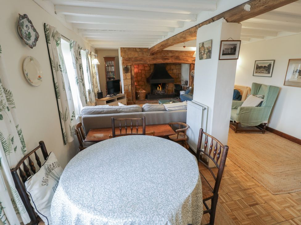 A living room with a table and sofa at Priors Mead in Claydon near Cropredy