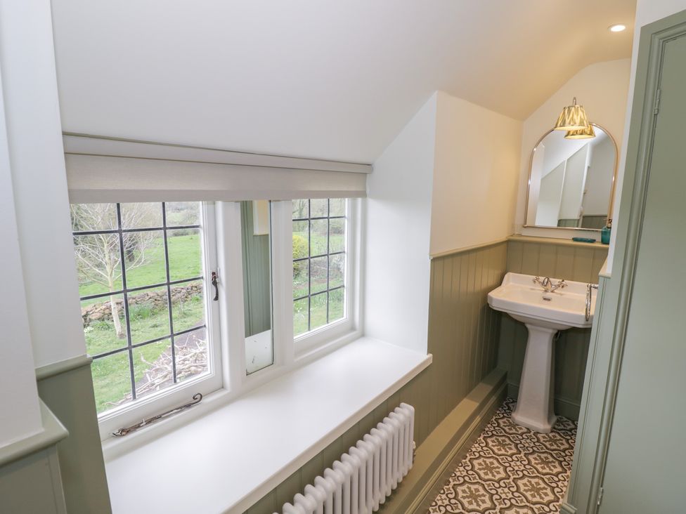A bathroom with a sink and window at Priors Mead in Claydon near Cropredy