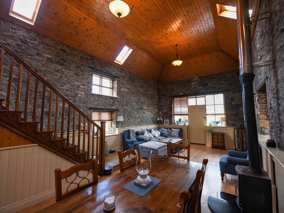 A living room with a staircase and seating area at Coach House Kilbeg near Borris-In-Ossory, County Laois