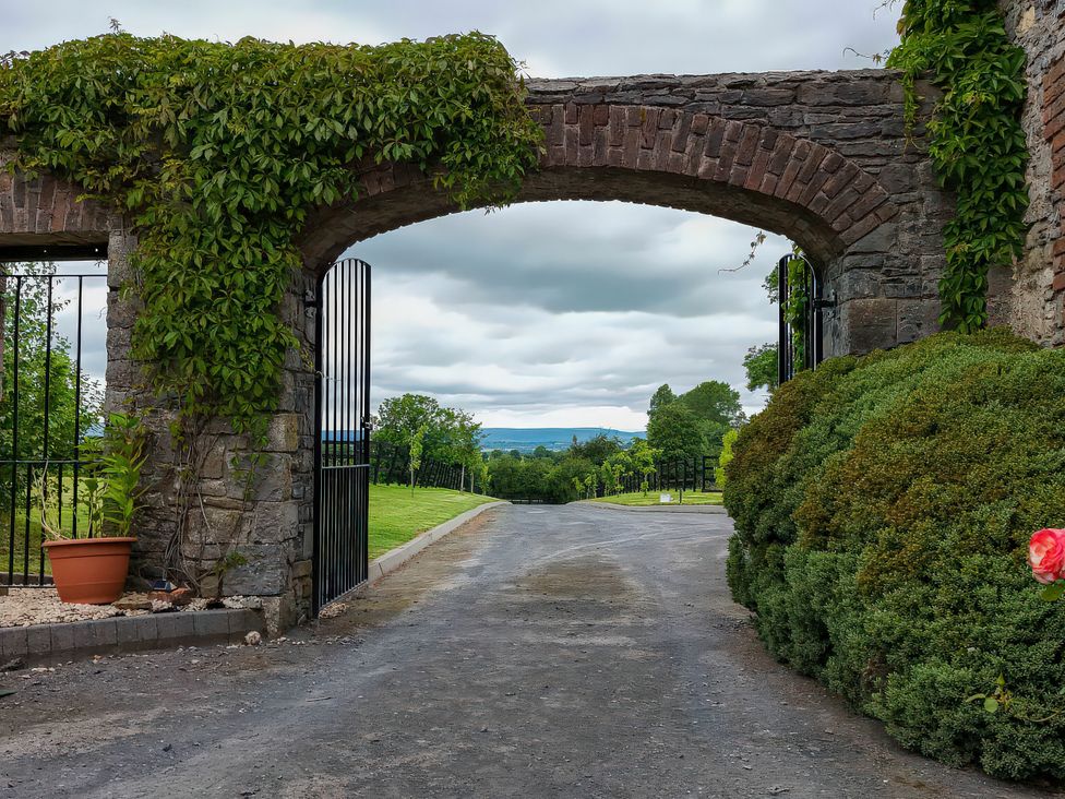 An archway with gates leading to a view of hills at Coach House Kilbeg near Borris-In-Ossory County Laois
