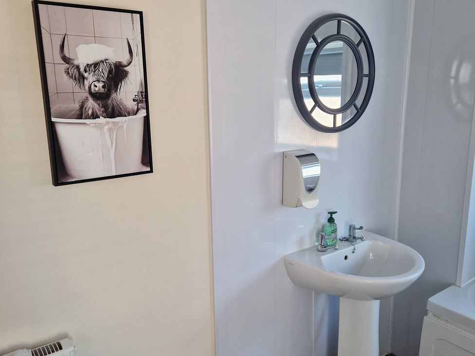 A bathroom with a sink and mirror at 18 Howard Street Scarborough