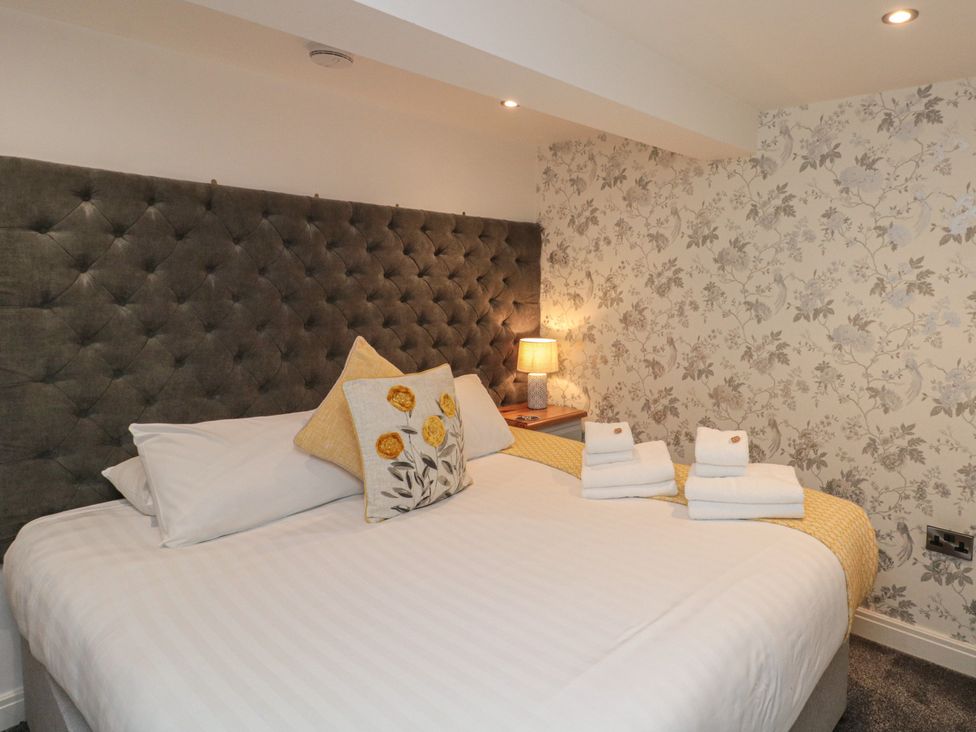 A bedroom with a bed and bedside table at Tornado @ Engine Shed in Whitby