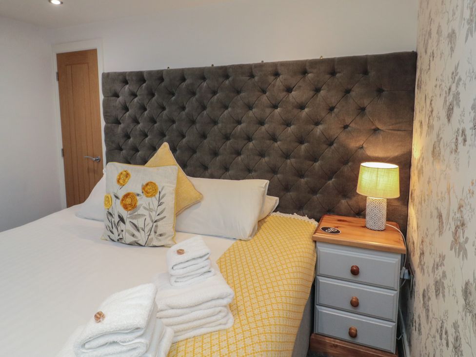 A bedroom with a bed and bedside table at Tornado @ Engine Shed in Whitby