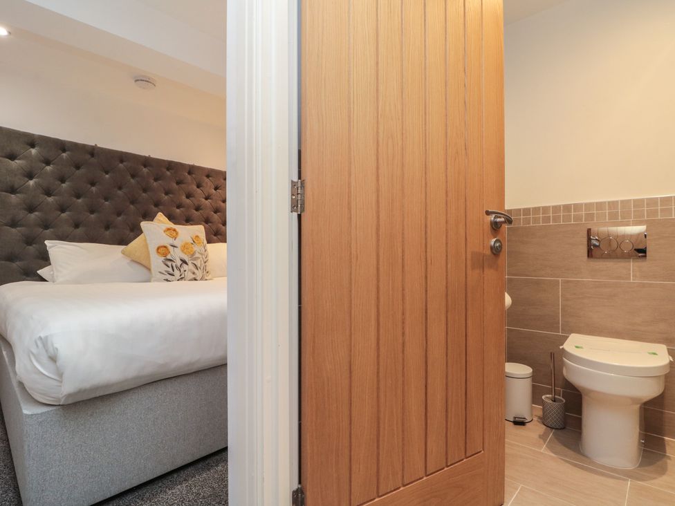 A bedroom with a bed and bathroom at Tornado @ Engine Shed Whitby