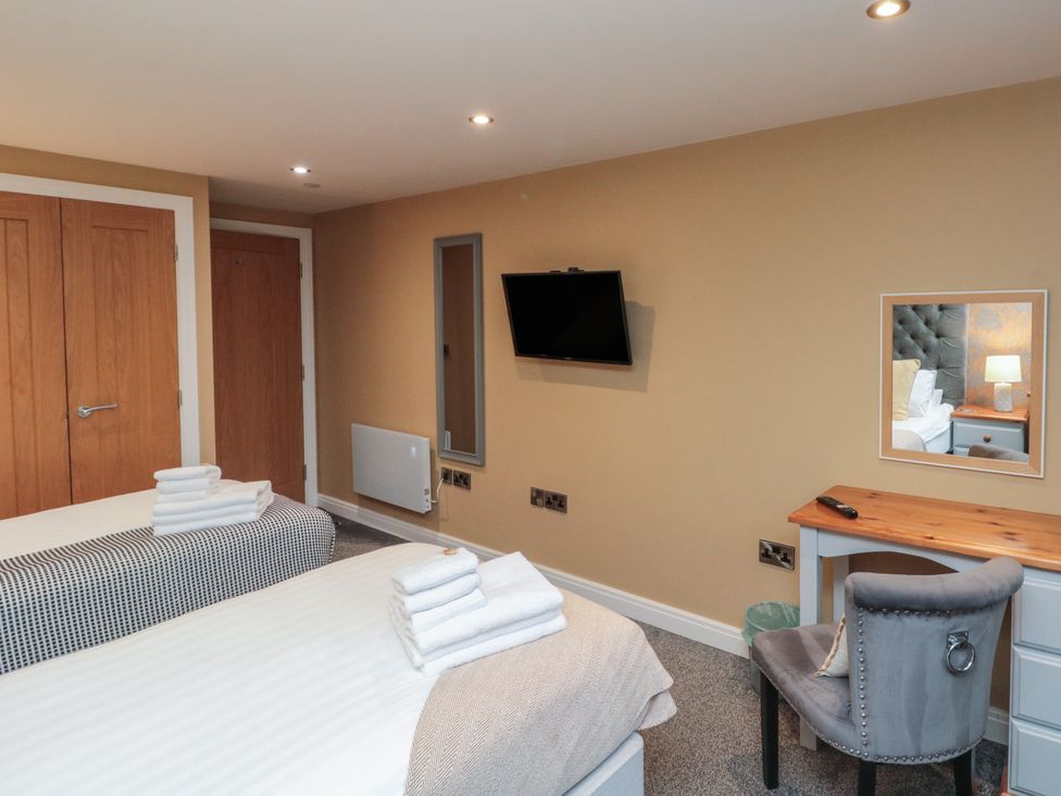 A bedroom with two beds and a television at Tornado @ Engine Shed Whitby