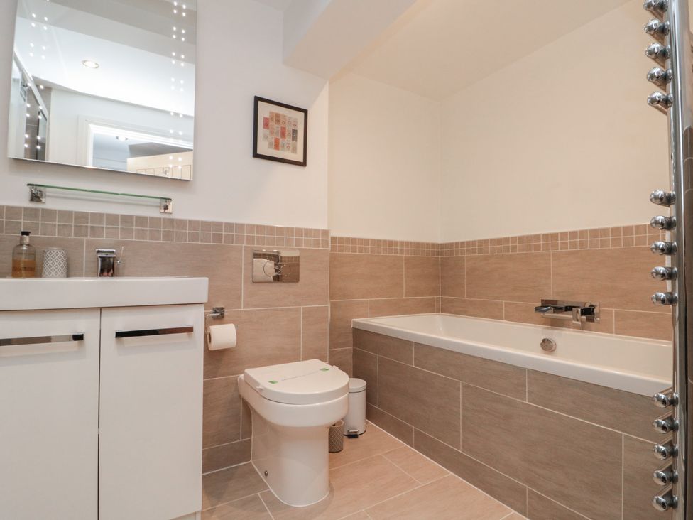 A bathroom with a bath tub and sink at Tornado @ Engine Shed in Whitby