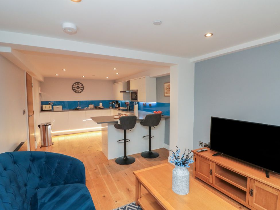 A kitchen with bar stools and a television at Blue Peter @ Engine Shed, Whitby