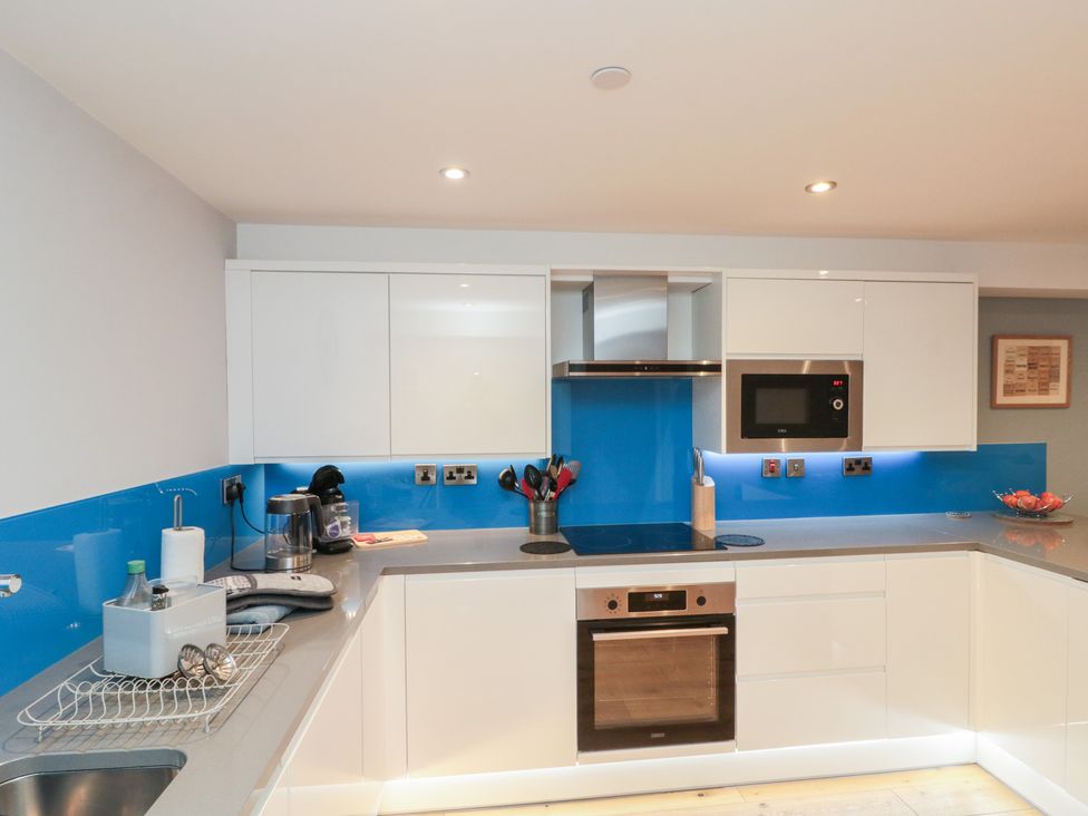 A kitchen with cabinets, oven, and microwave at Blue Peter @ Engine Shed Whitby