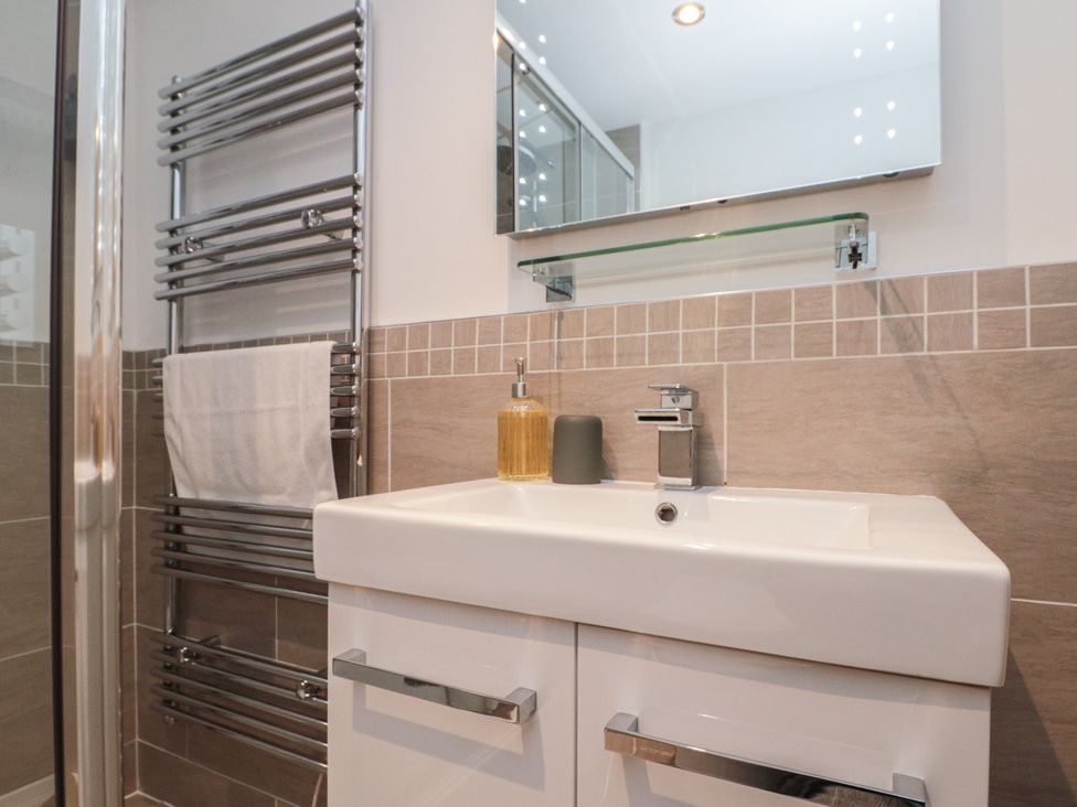 A bathroom with sink and towel rail at Blue Peter @ Engine Shed in Whitby