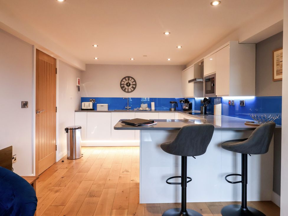 A kitchen with bar stools and modern fixtures at Blue Peter @ Engine Shed Whitby