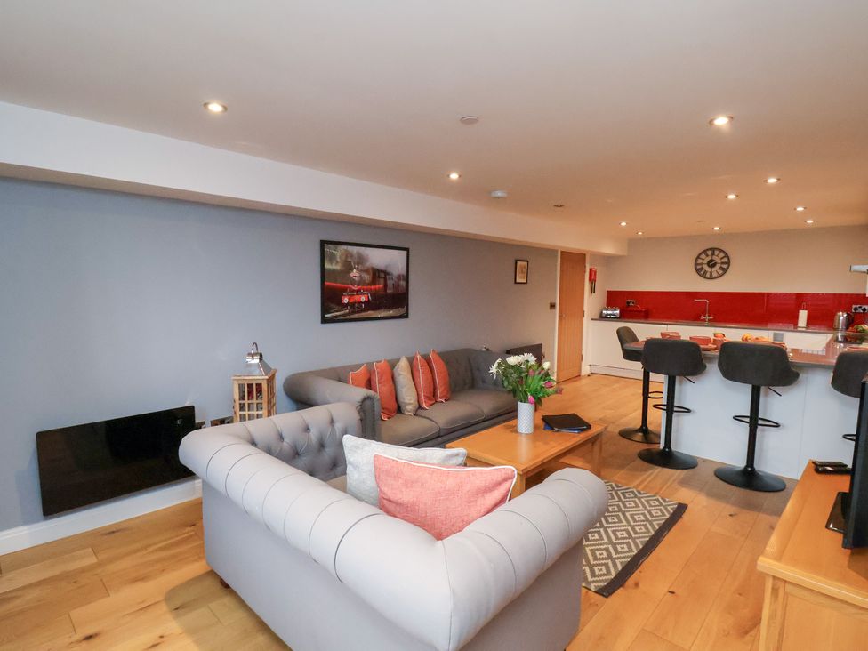 A living room with a sofa and kitchen island at Olton Hall @ Engine Shed in Whitby