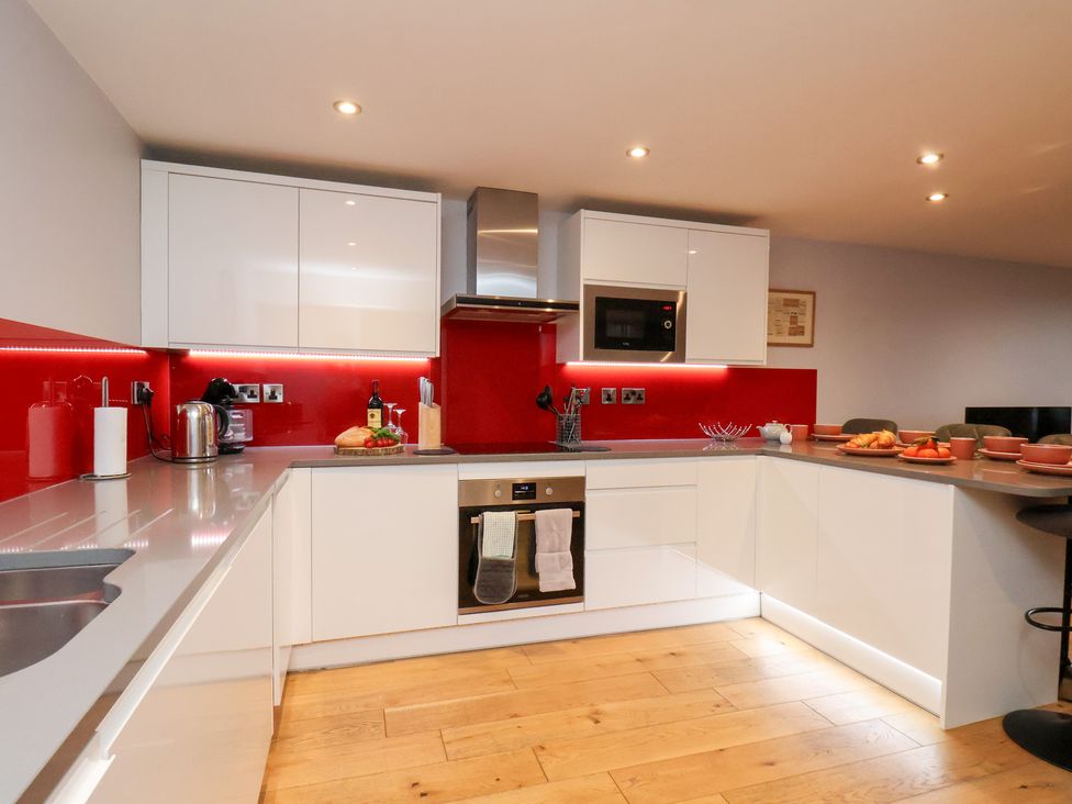 A kitchen with modern cabinets and appliances at Olton Hall @ Engine Shed in Whitby