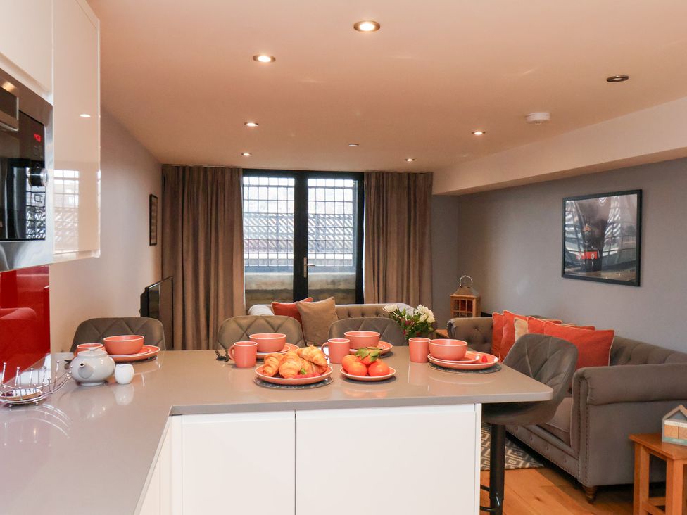 A kitchen with a sofa and dining table at Olton Hall @ Engine Shed, Whitby