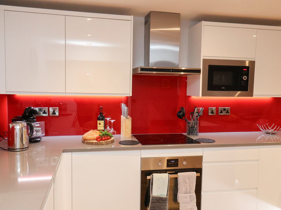 A kitchen with modern appliances and food items at Olton Hall @ Engine Shed Whitby