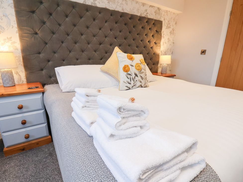 A bedroom with a bed and towels at Olton Hall @ Engine Shed, Whitby