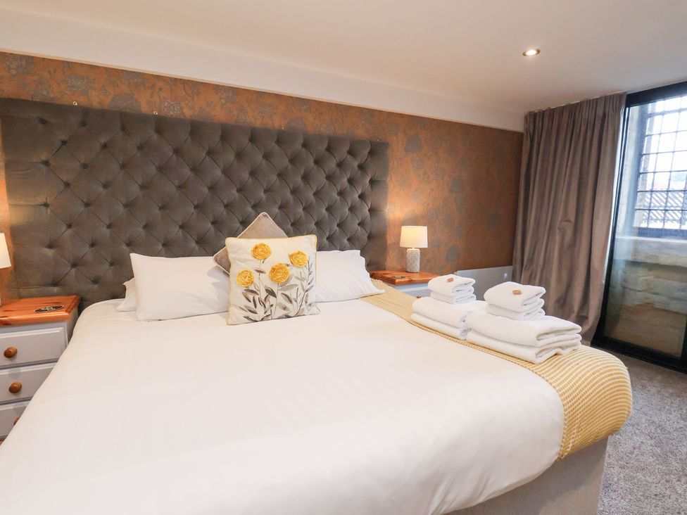 A bedroom with a bed and bedside tables at Olton Hall @ Engine Shed in Whitby